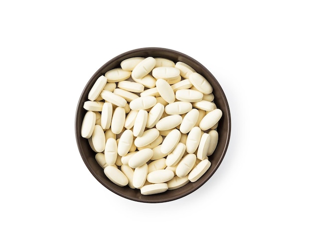 White tablet pills in bowl clipping path isolated