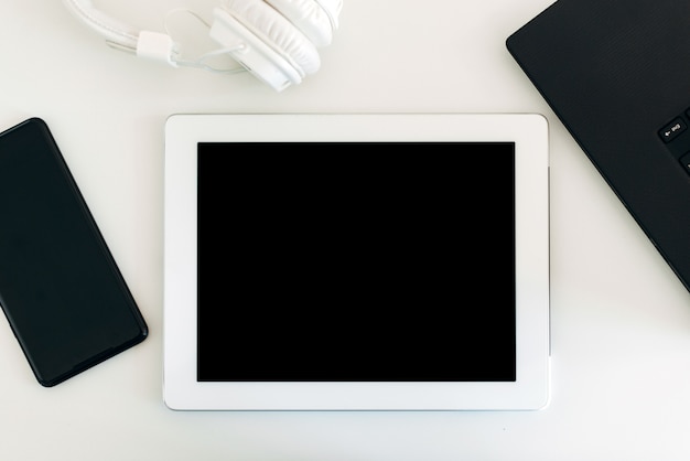 White tablet and a smartphone on the desk