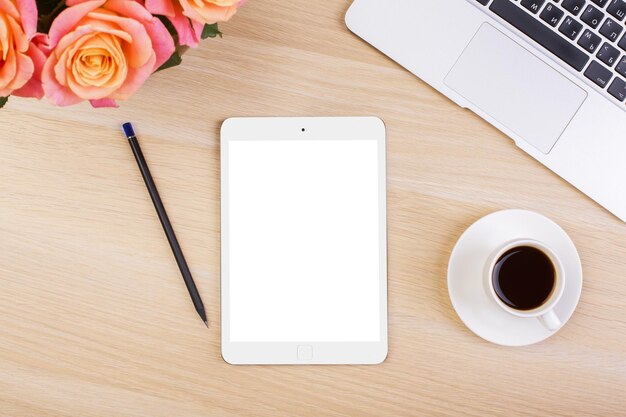 White tablet on woman's desktop