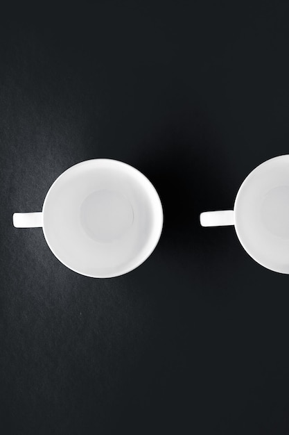 White tableware crockery set empty cup on black flatlay\
background