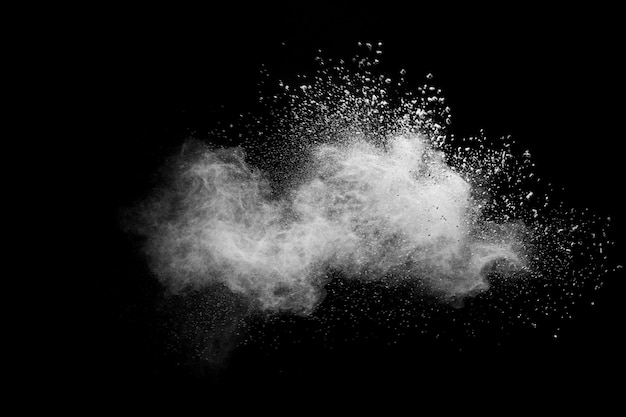 White talcume powder explosion on black background. White dust particles splash.