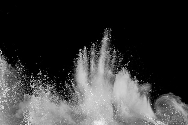 White talcume powder explosion on black background. White dust splashing.