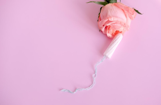 White tampon and pink rose On a pink backgroundcopy space