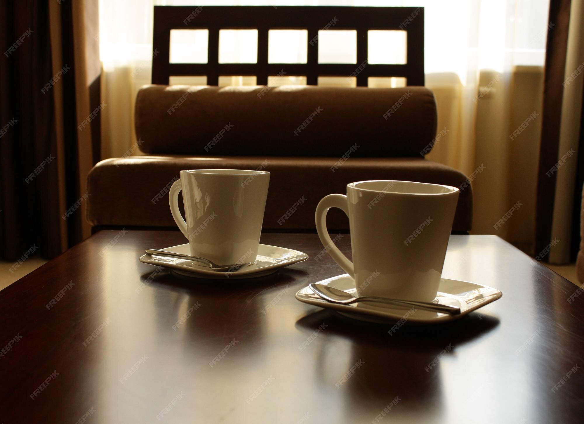 Premium Photo White tea crockery on brown tea table