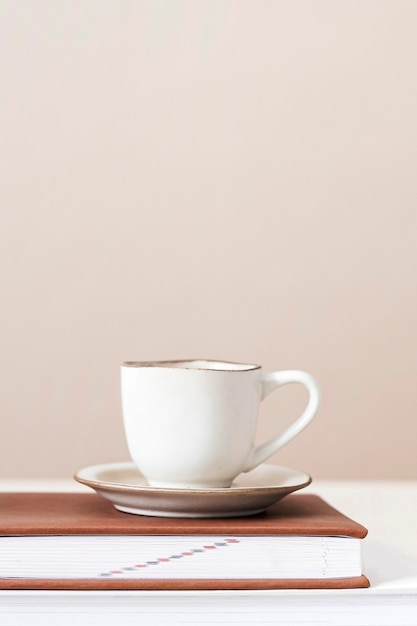 White tea cup on a book