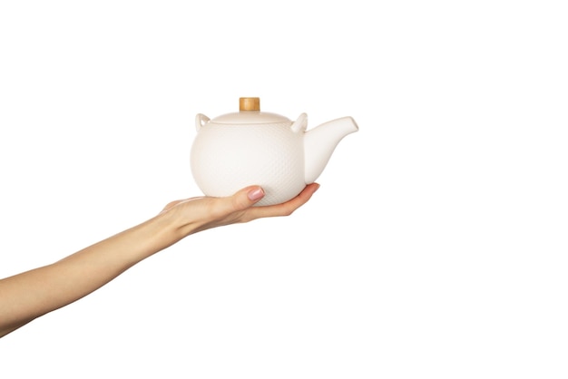 White teapot in hands isolated on white background