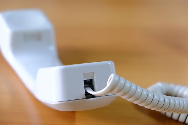 White telephone receiver from the 1990s Shallow depth of field closeup