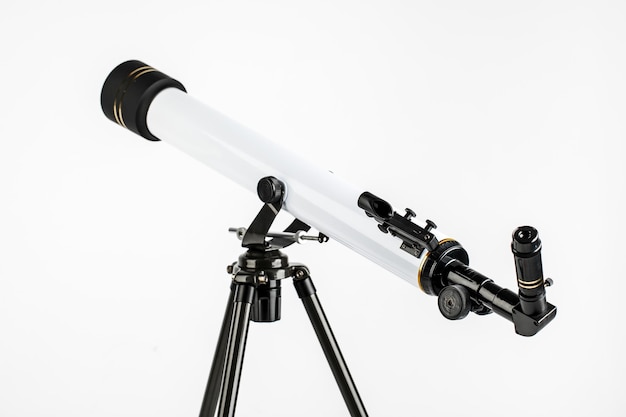 White telescope on tripod isolated on white background