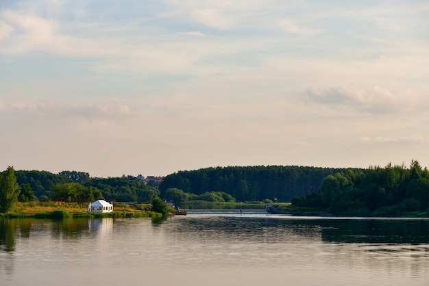 White tent for relaxing on the lake in summer.