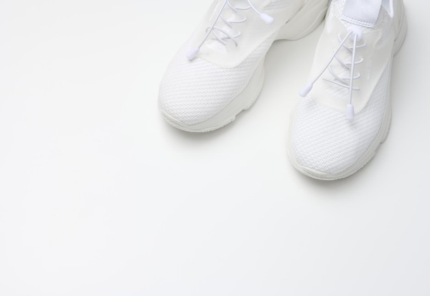 white textile sneakers on a white background top view