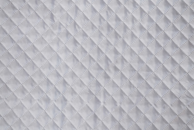 Photo white textile texture with checkered mesh embossing background