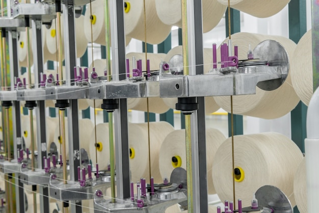 White textile yarn on the warping machine. machinery and equipment in a textile factory