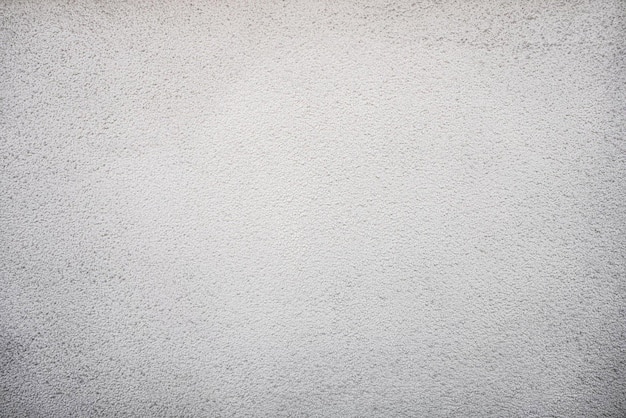 A white textured wall with a black and white background