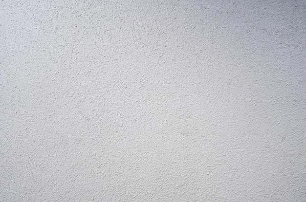 A white textured wall with a blue sky in the background