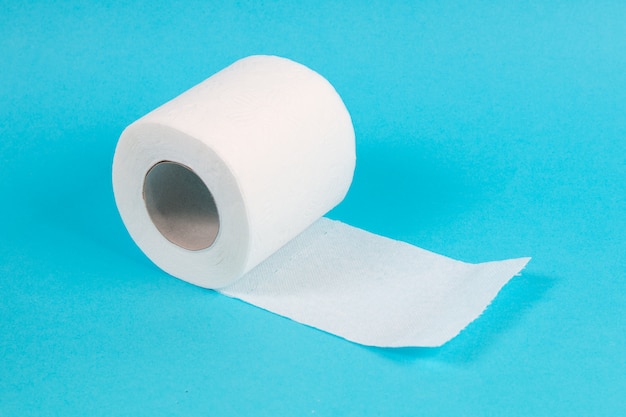 White toilet paper roll on blue background