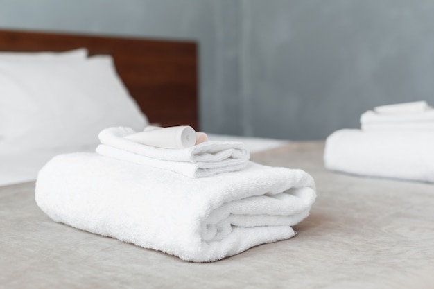 White towel on bed in guest room for hotel customer