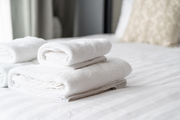 white towel decoration on bed 