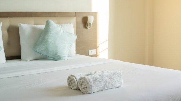 White towel shampoo and soap on a bed.