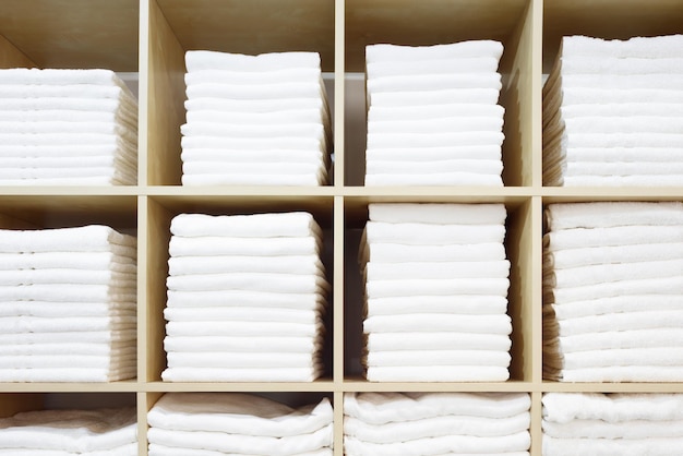 White Towels Folded and Stacked on a Shelf