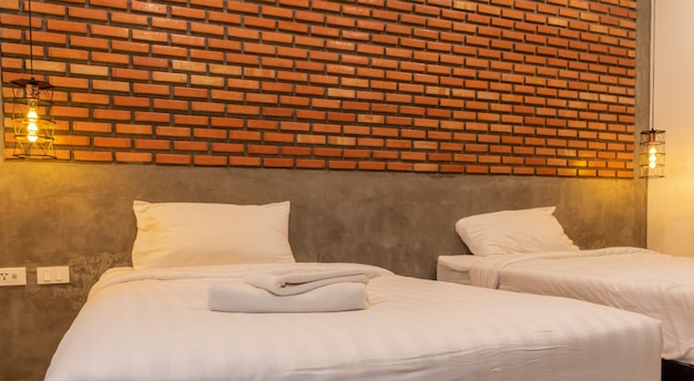 White towels in vintage and loft style bedrooms in the room decorate the walls with brown bricks