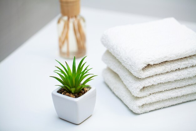 Photo white towels on white table at the bathroom