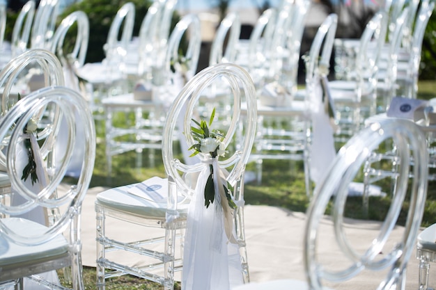 White transparent chairs at the wedding ceremony