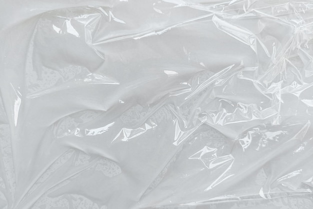 White transparent crumpled and creased plastic poster texture background wet plastic wrap on the white background