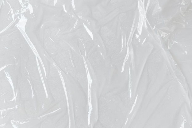 White transparent crumpled and creased plastic poster texture background wet plastic wrap on the white background