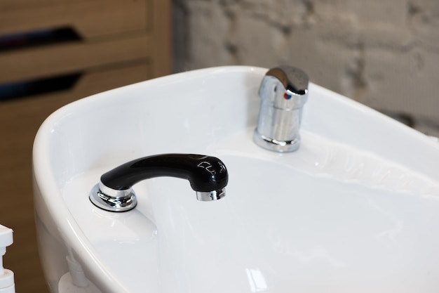 White triple hair washing sink for hairdresser salon closeup