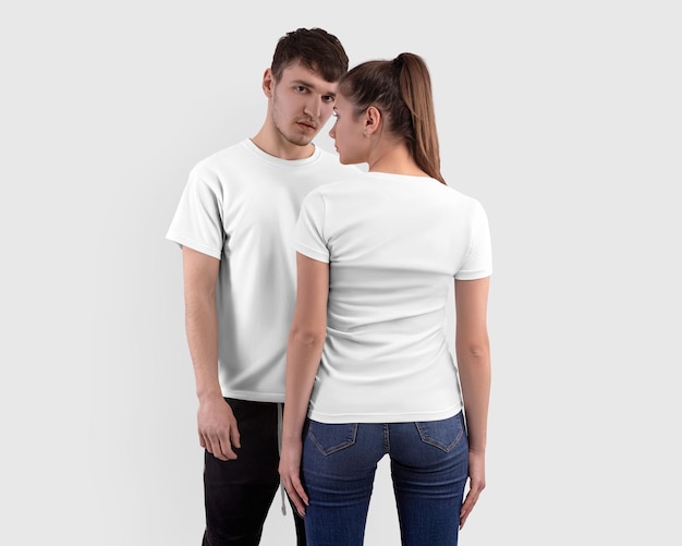 white tshirt on a girl and a guy isolated on background in the studio clothes for design