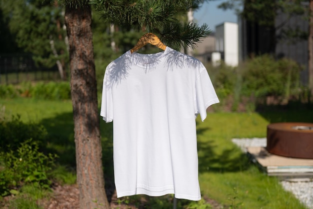White Tshirt hanging on a hanger layout