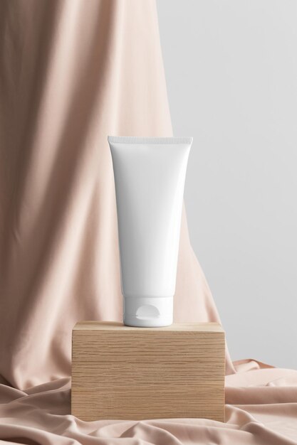 White tube of cream mockup with a beige textile