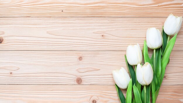 white tulip flowers on wooden table. love, romantic and Valentine Day holiday Concept