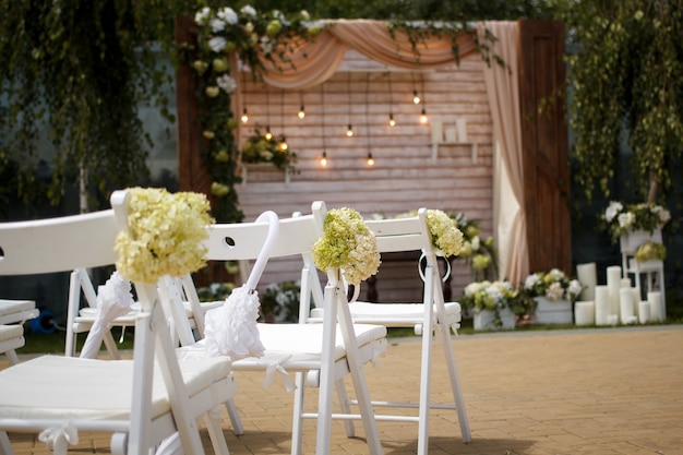 White umbrella on the back of a chair at a wedding ceremony, selective focus