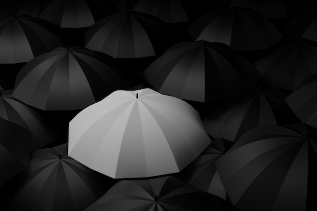 Фото Белый зонт посреди черного. концепция различий