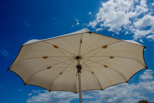 White umbrellas open on the beach