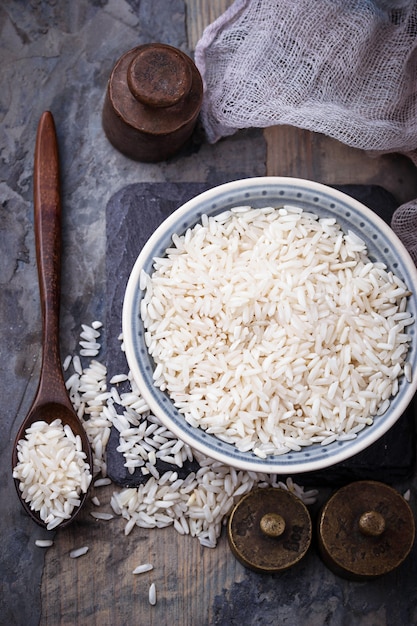 White uncooked rice on concrete background