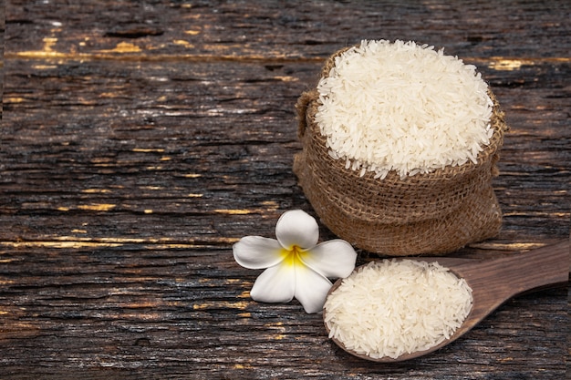 White uncooked rice with White uncooked  rice on wooden spoon