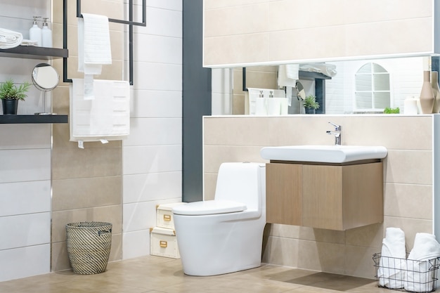 White urinal and washbasin and shower in granite bathroom