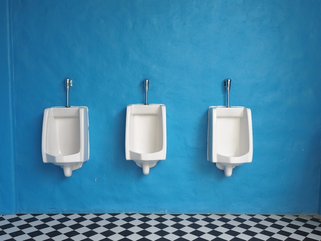  white urinals in mens bathroom