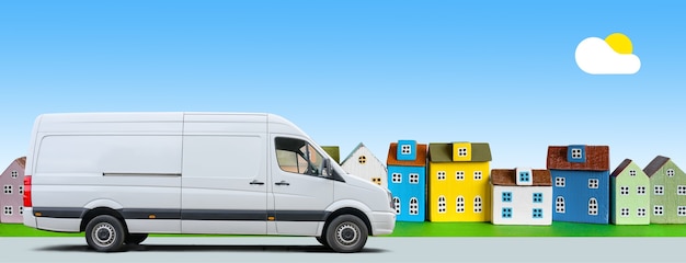 White van drives along a row of colorful miniature houses on\
blue sky background