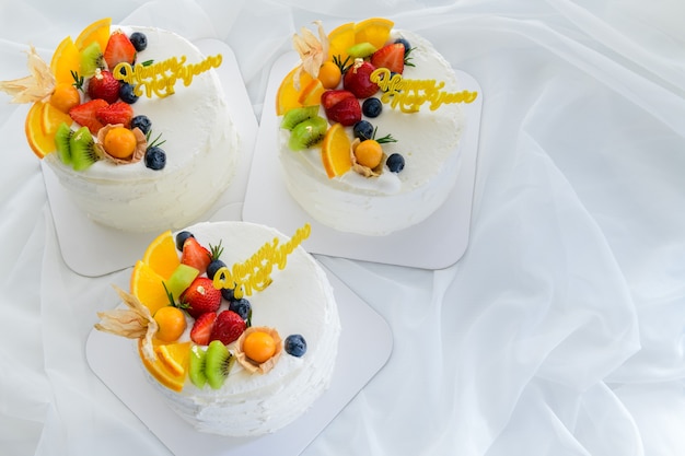 White vanilla cake with happy new year and topped with orange