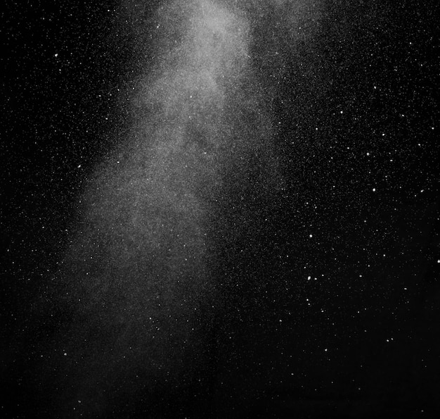 White vapour spray steam from air saturator. Smoke fragments on a black background. Abstract background, design element, for overlay on pictures