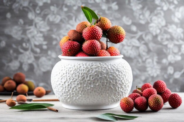 a white vase with a bunch of berries on it and a sprig of leaves on the table