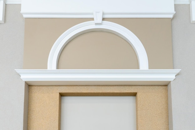 White vertical and arched molding on beige wall Renovation in the apartment The walls and ceilings are decorated in a classic style Modern laconic interior