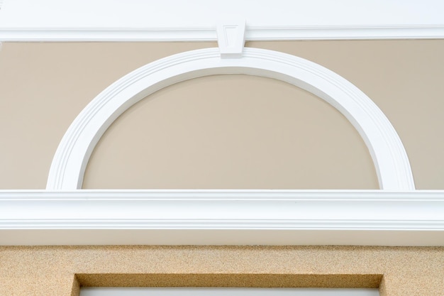 White vertical and arched molding on beige wall Renovation in the apartment The walls and ceilings are decorated in a classic style Modern laconic interior