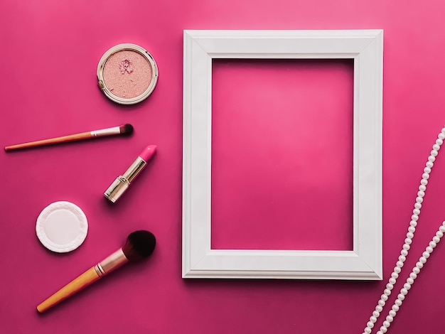 White vertical art frame makeup products and pearl jewellery on pink background as flatlay design artwork print or photo album