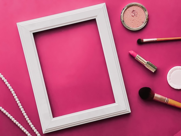 White vertical art frame makeup products and pearl jewellery on pink background as flatlay design artwork print or photo album