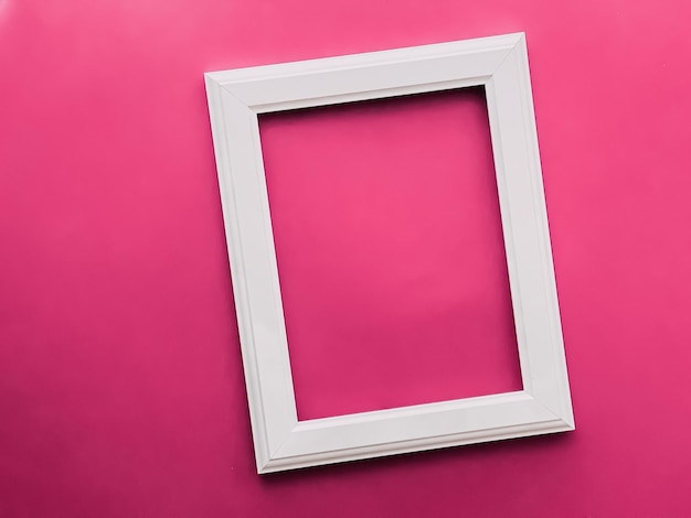 White vertical art frame on pink background as flatlay design artwork print or photo album