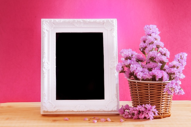 White vintage photo frame with sweet statice flower